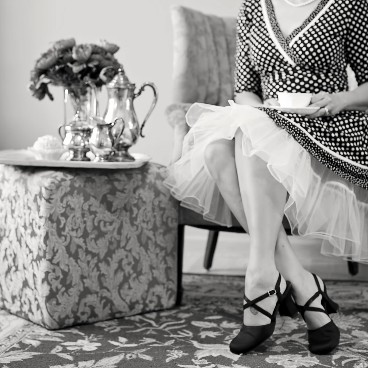 lady sitting at a tea party - black and white photo