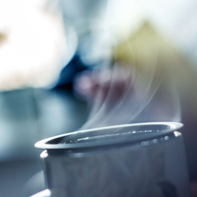 steam escaping from tea steeping in a cup